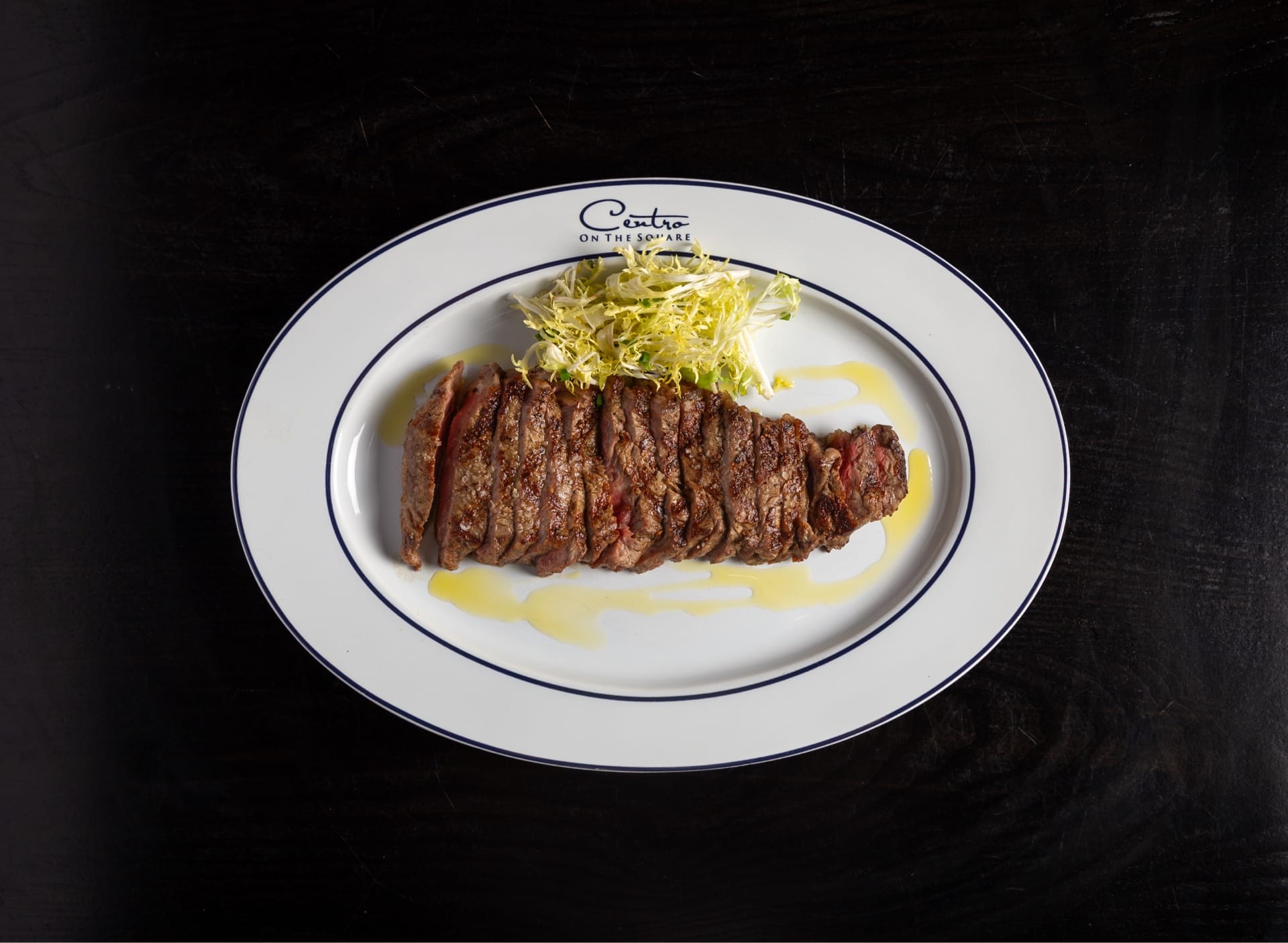 Premium steak plated at Centro on the Square, set for a corporate dinner in McKinney